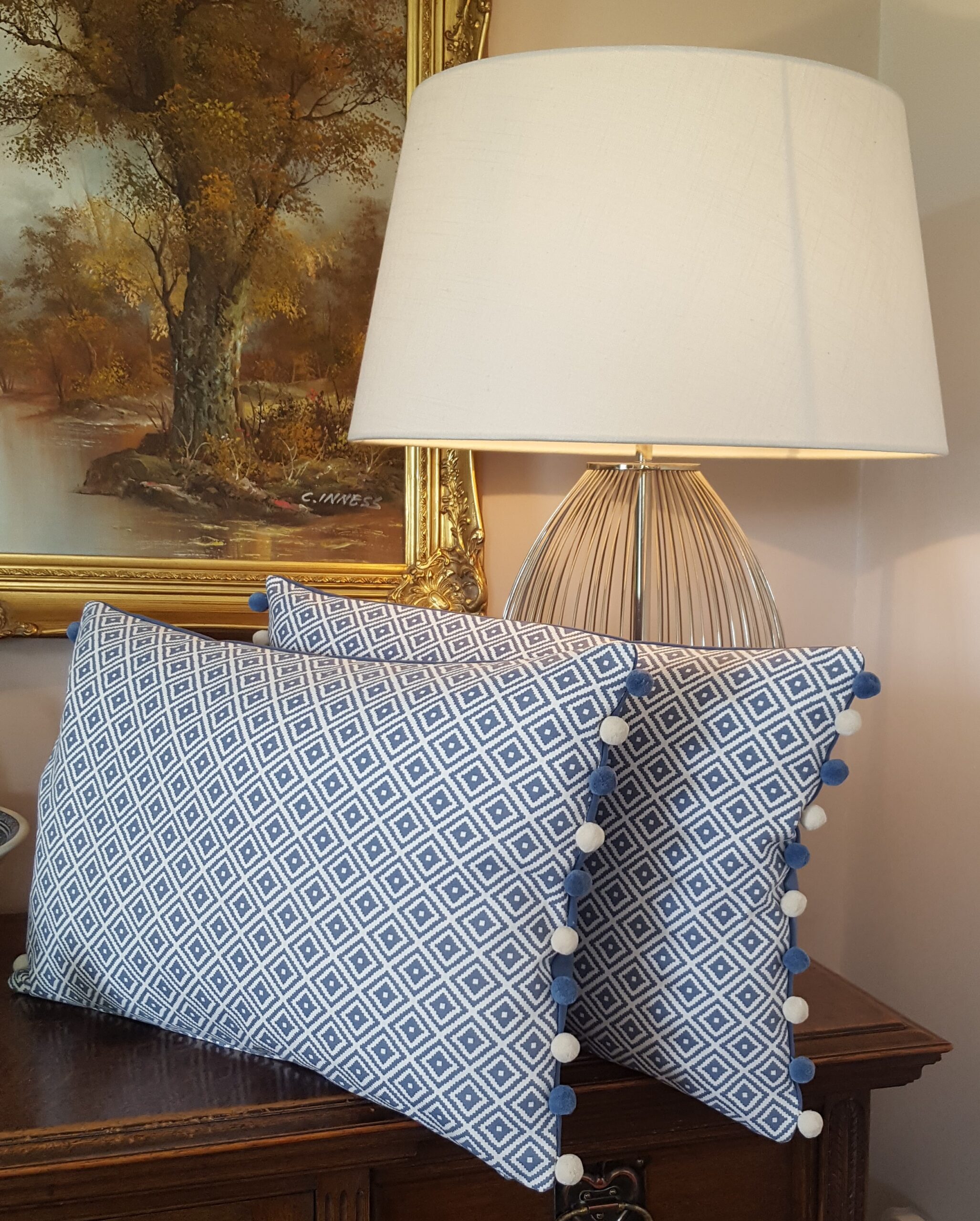 Handmade blue and white pom pom cushion